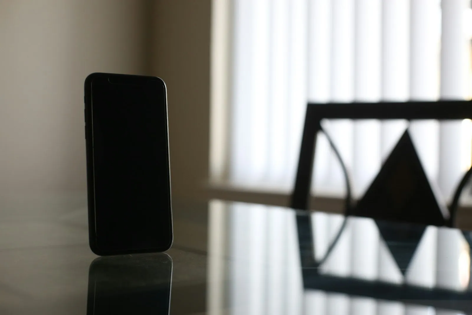 A phone lying on a table, screen off