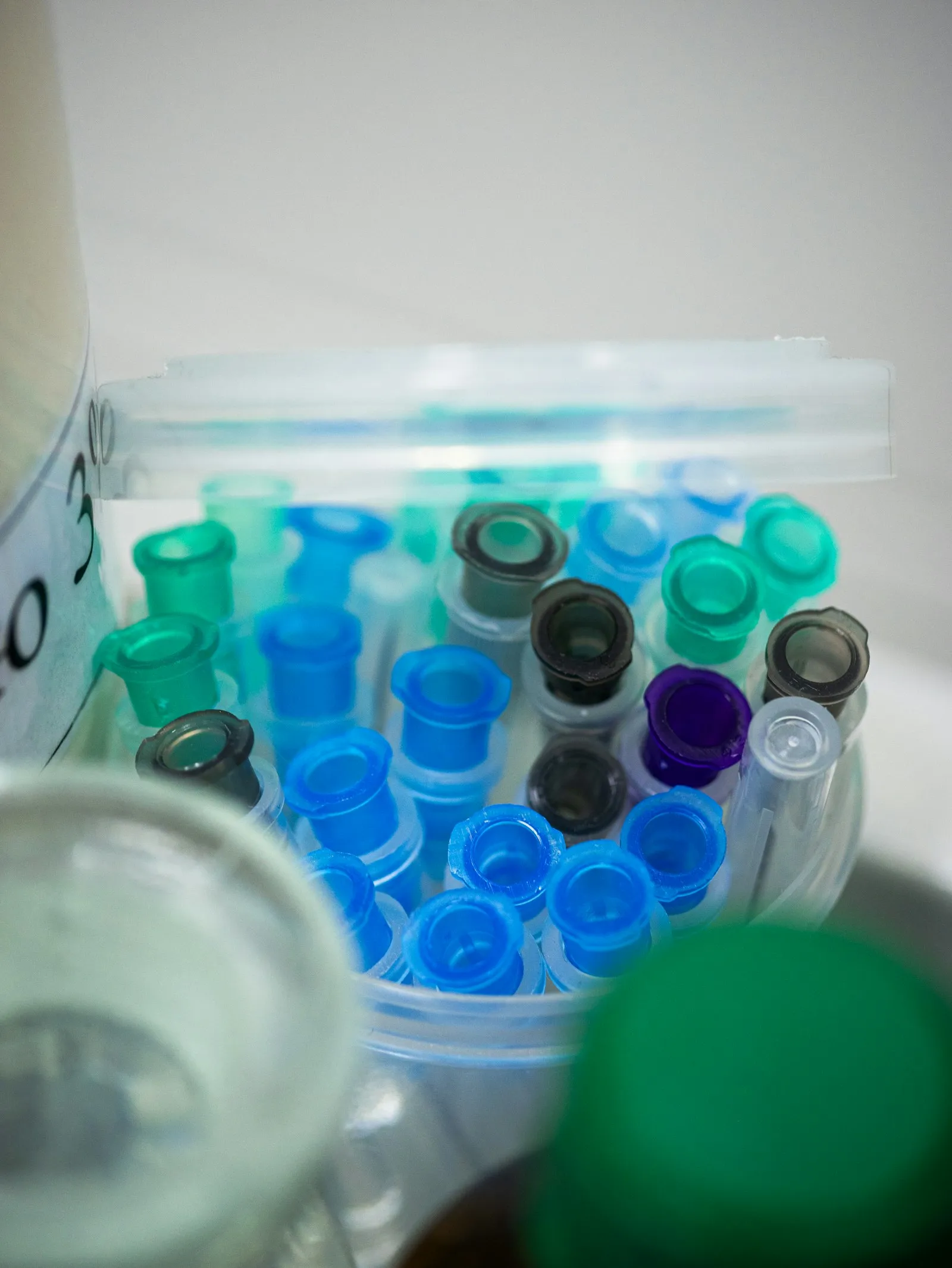 Coloured pipette tips in a container